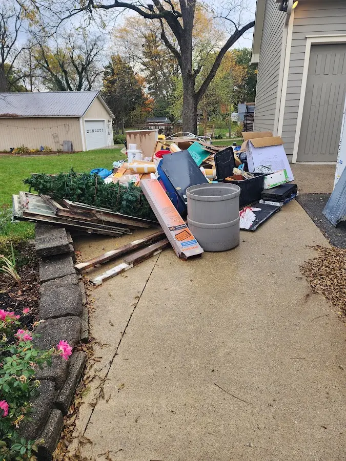 Dumpster being loaded with debris for Roofing Dumpster Rental in St. Charles